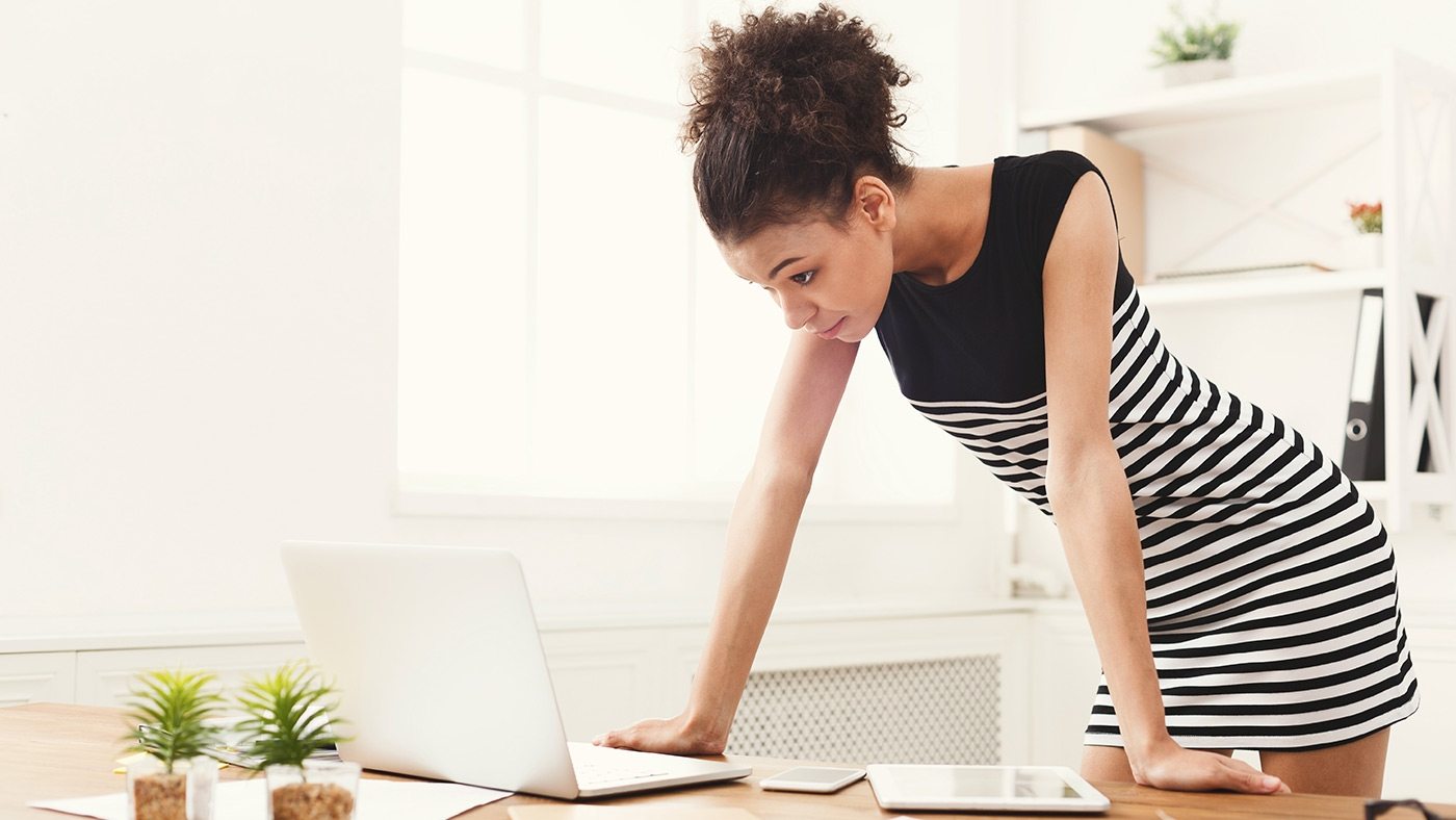 business-woman-working-on-laptop-at-office-PRFJKQJ