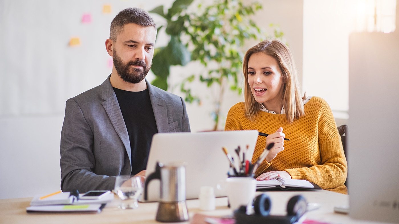two-business-people-with-wheelchair-in-the-office-P7XLSBC