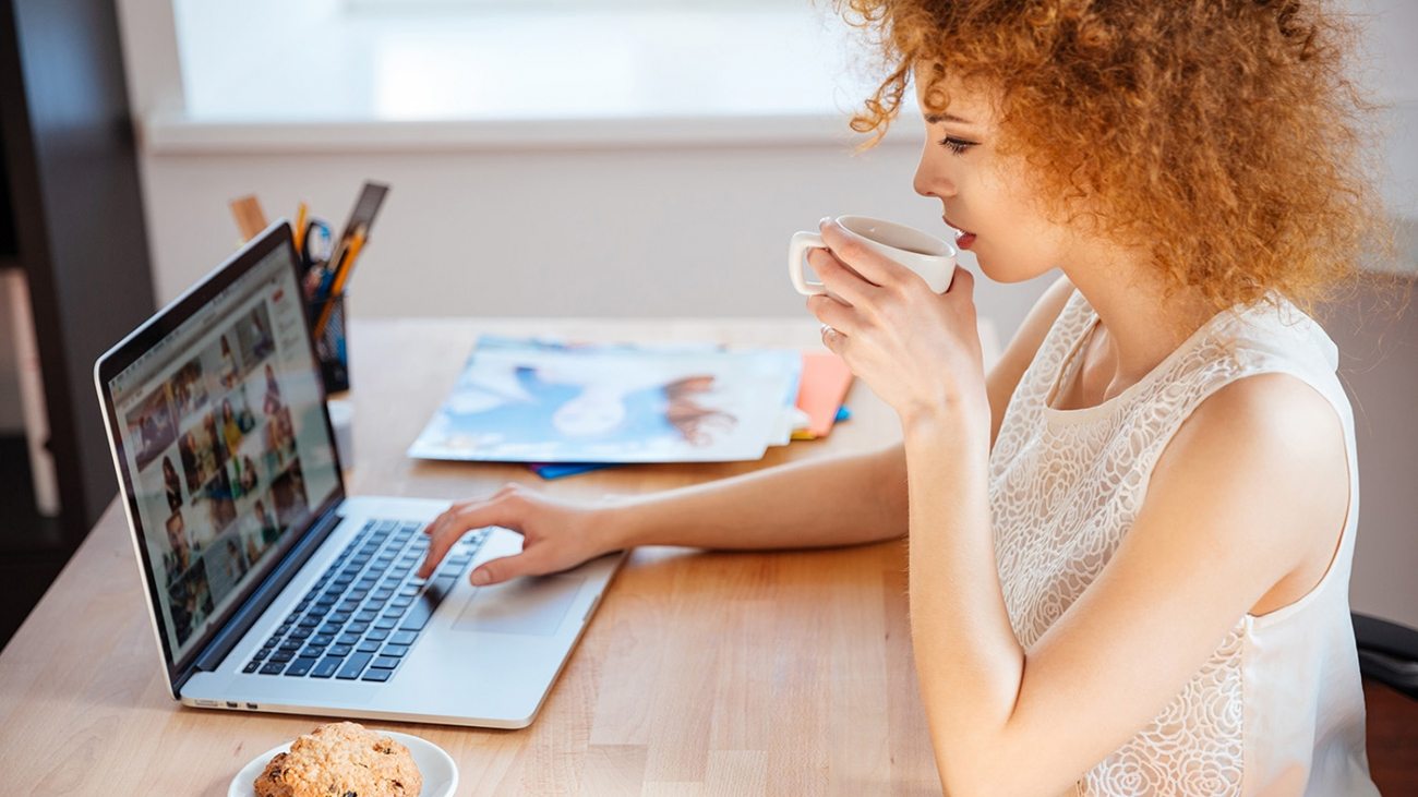 woman-photographer-drinking-coffee-and-working-PJNBP6U