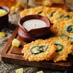 Jalapeno Cheese Crisps with Greek Yogurt Pepper Sauce on a wood background. toning. selective focus