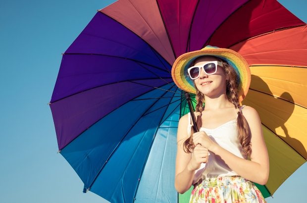 teen-girl-with-umbrella-standing-on-the-beach-at-PMEQ6S8