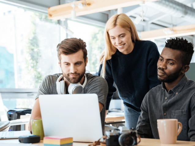 happy-colleagues-sitting-in-office-coworking-PHYA6TG