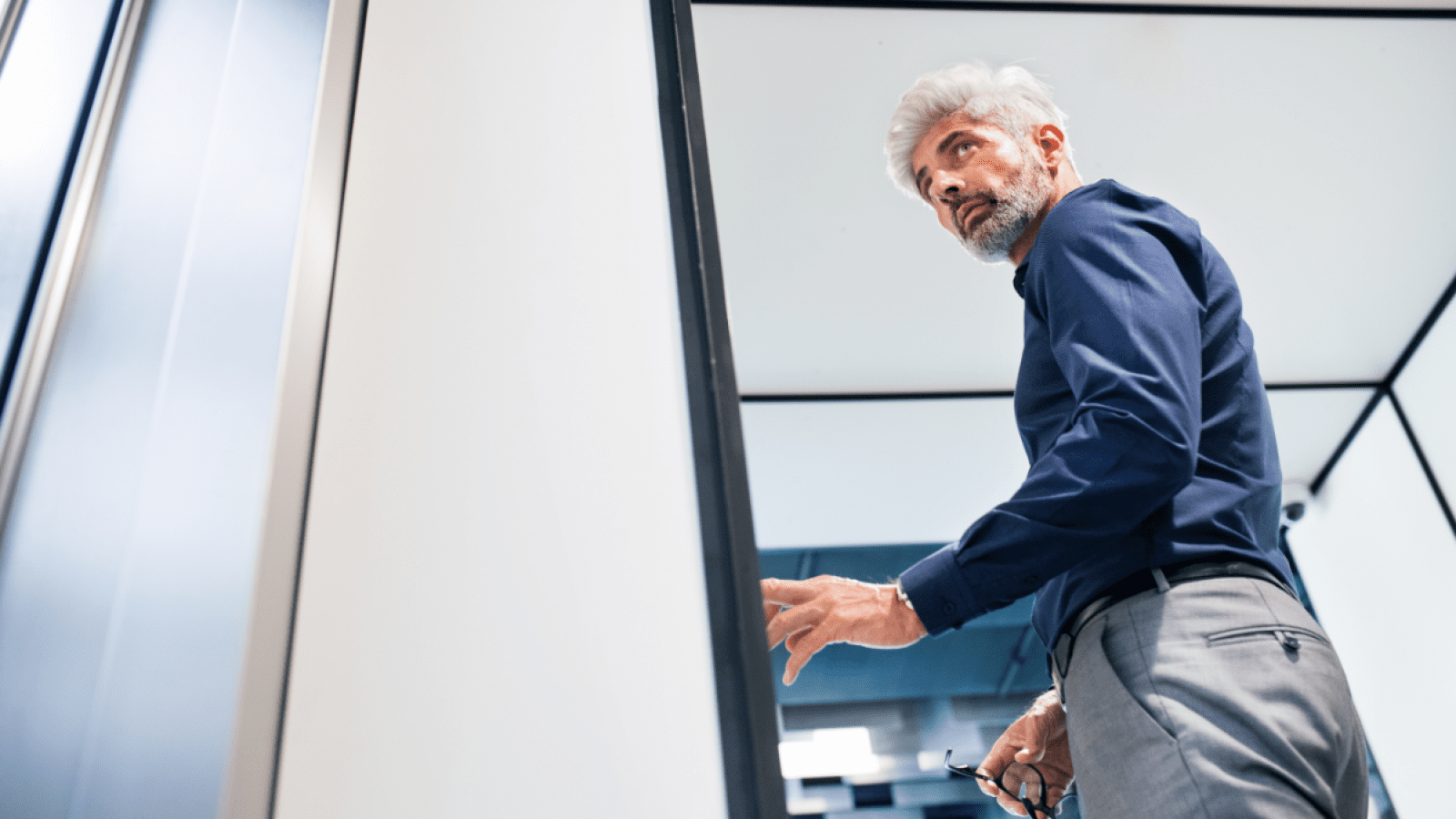 mature-businessman-in-the-office-standing-P4MENHG