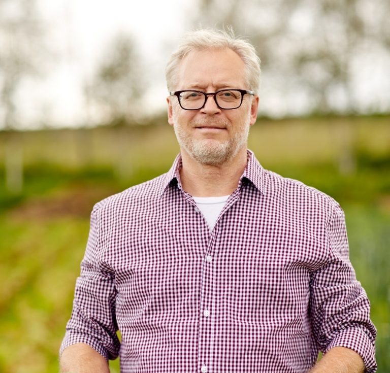 senior-man-with-box-of-vegetables-on-farm-PHMQ8WB@2x