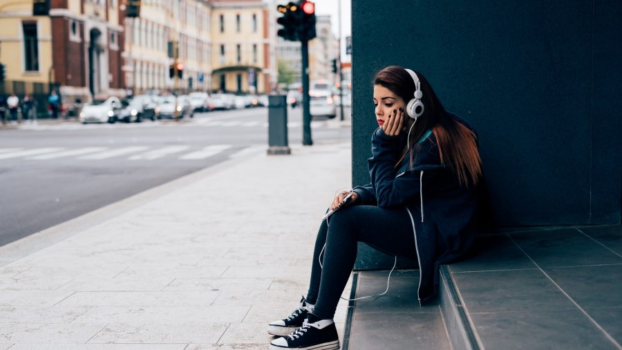 young-woman-sitting-on-a-step-PE6MPZ9
