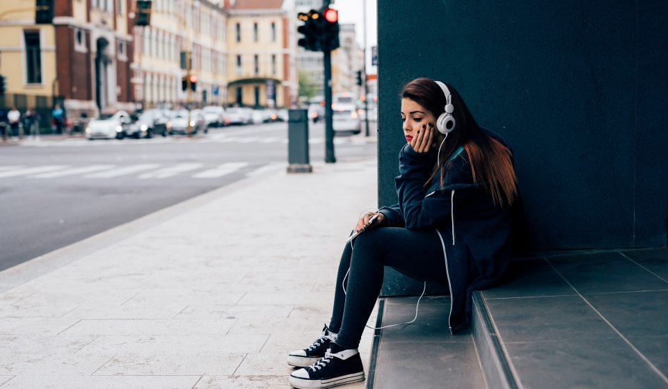 young-woman-sitting-on-a-step-PE6MPZ9