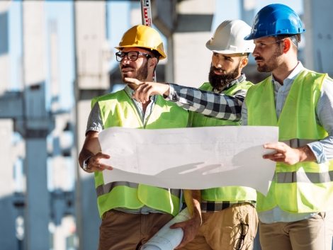 Portrait of construction engineers working on building site together