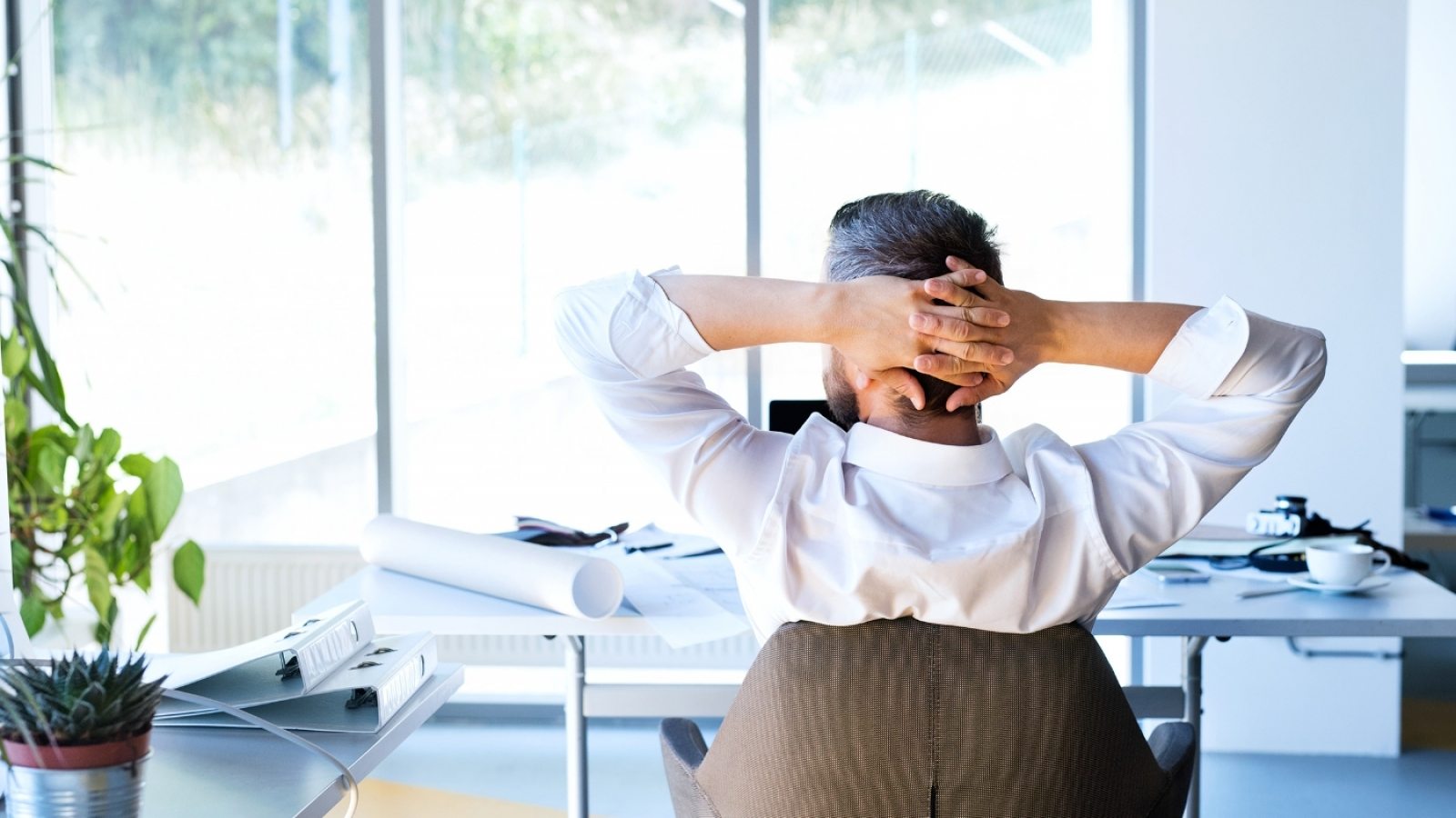 Businessman at the desk in his office resting.