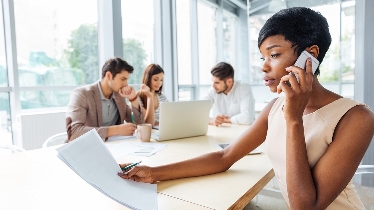 serious-businesswoman-with-documents-talking-on-P9Q6LX6