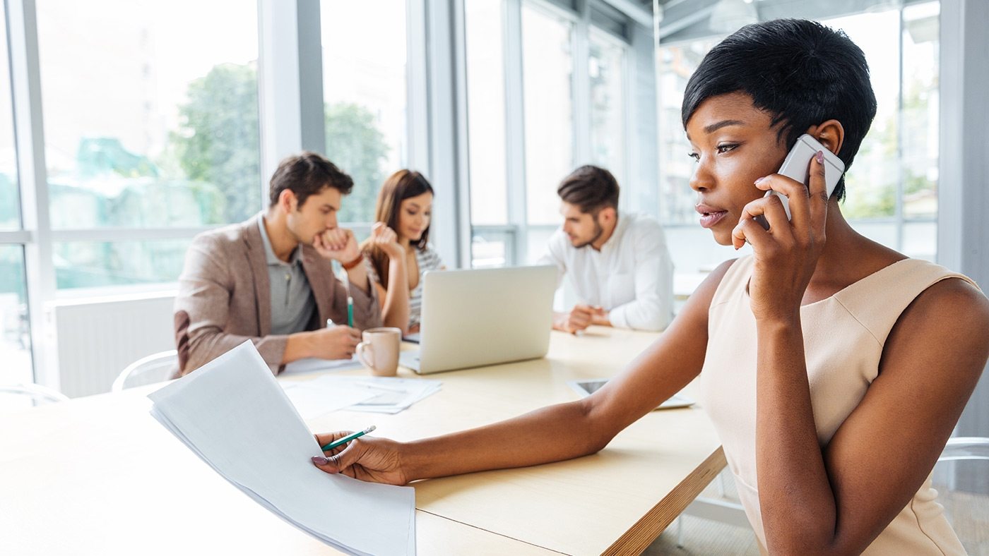 serious-businesswoman-with-documents-talking-on-P9Q6LX6