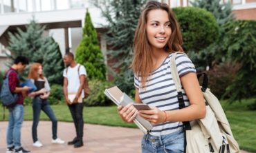 happy-woman-student-with-backpack-holding-books-PNFUGG7(1)