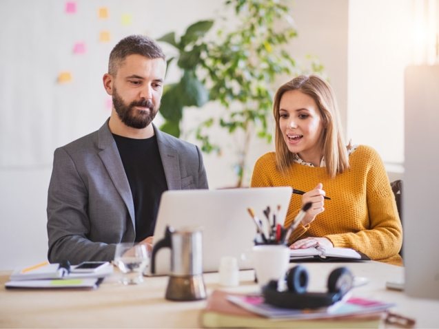 two-business-people-with-wheelchair-in-the-office-P7XLSBC