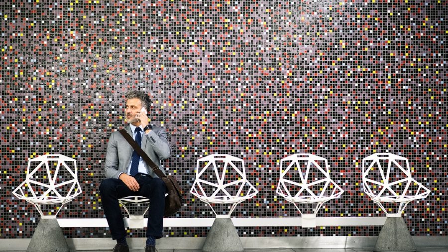Mature-businessman-with-smartphone-in-a-metro-station.