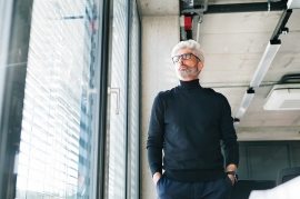 mature-businessman-with-gray-hair-in-the-office-PF9SFHW