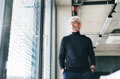 mature-businessman-with-gray-hair-in-the-office-PF9SFHW