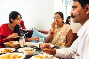family-having-indian-food-PU9L7XJ