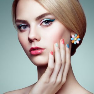 Portrait of beautiful sensual woman with elegant hairstyle.  Perfect makeup. Blonde girl. Fashion photo. Jewelry