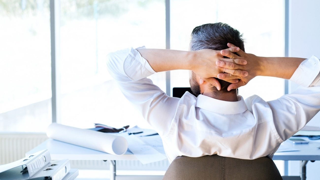 Businessman at the desk in his office resting.