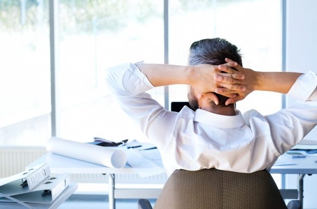 Businessman at the desk in his office resting.