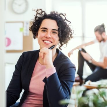 a-portrait-of-young-businesswoman-sitting-in-a-JABCPXQ